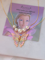 Butterfly necklace with pearl pendant on a branded card
